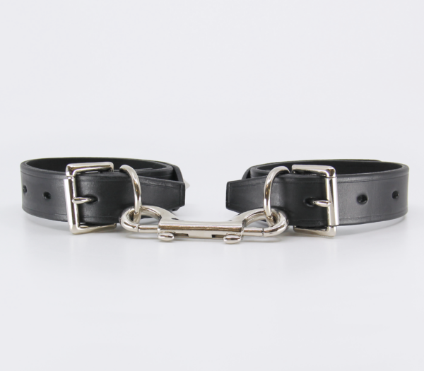Back view of leather wrist cuffs with double ended snap join.