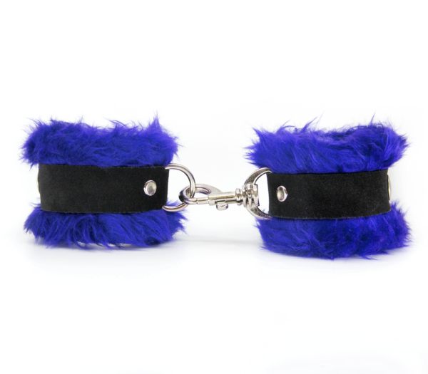 Side view of blue fluffy wrist cuffs with black centre strap and silver snap.
