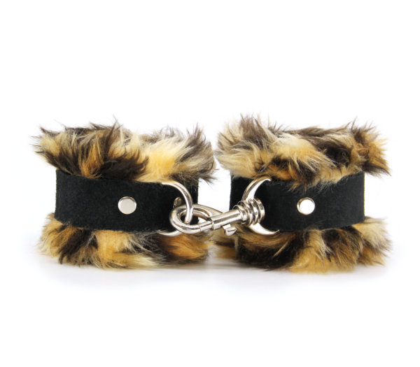 Front view of striped brown animal print fluffy wrist cuffs with black centre strap and silver snap.