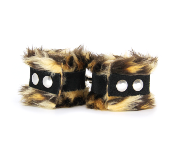 Back view of striped brown animal print fluffy wrist cuffs with black centre strap and silver snap buttons.