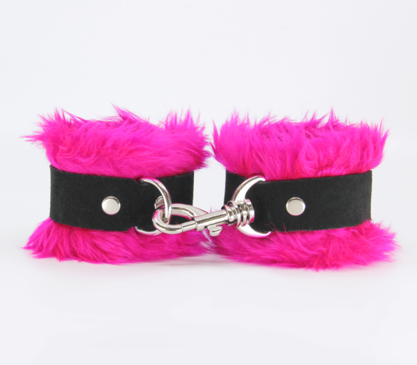 Front view of pink fluffy wrist cuffs with black centre strap and silver snap.