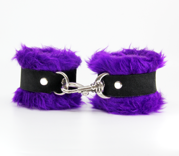 Front view of purple fluffy wrist cuffs with black centre strap and silver snap.