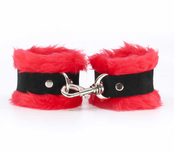 Front view of red fluffy wrist cuffs with black centre strap and silver snap.